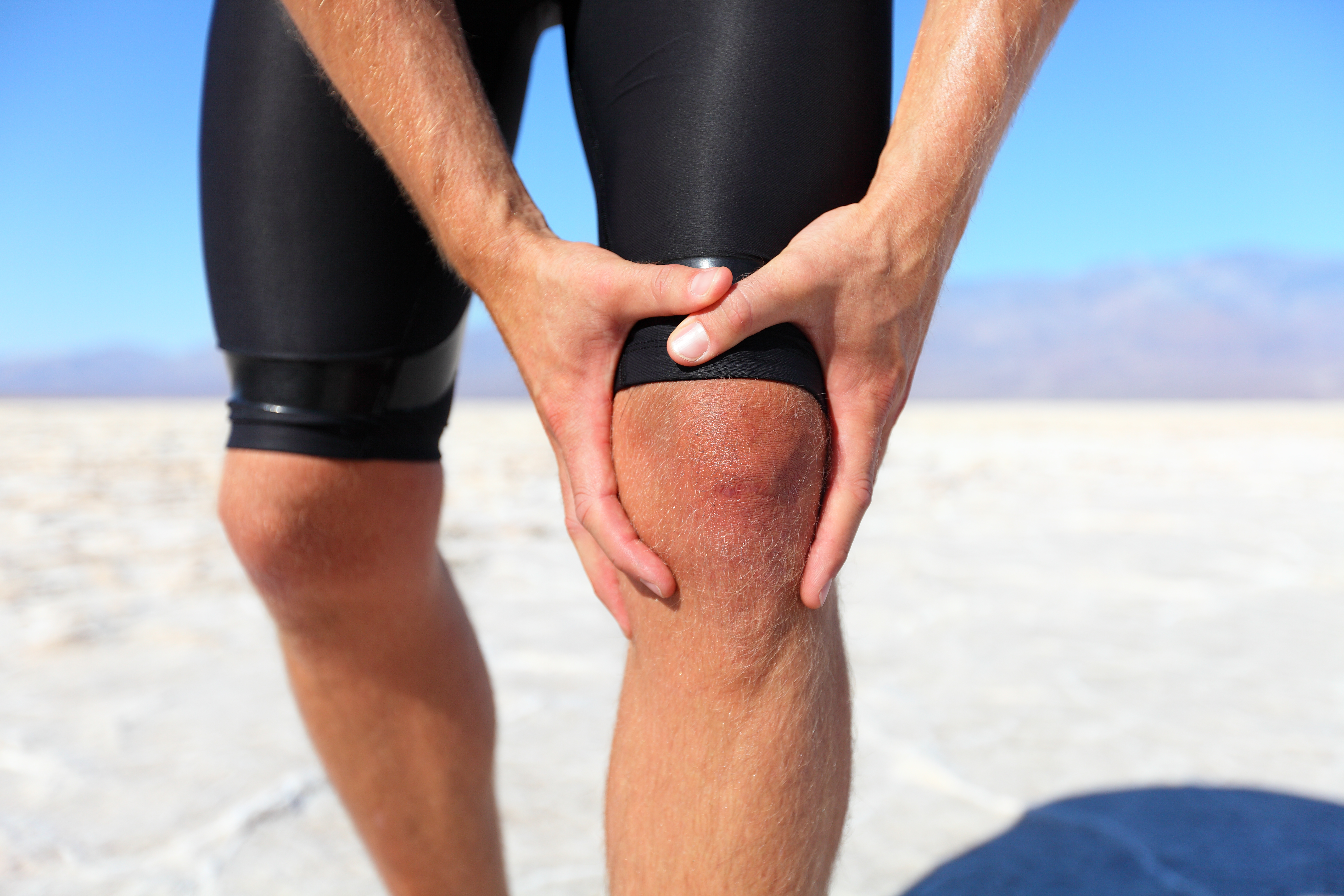 Injuries - sports running knee injury on man