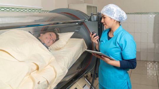 Hyperbaric Oxygen Therapy woman in chamber with nurse